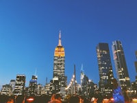 the empire state building is lit up at night